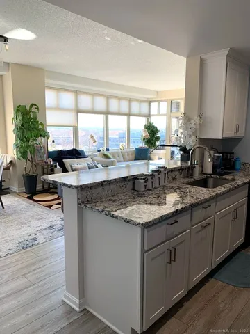 a kitchen with stainless steel appliances granite countertop a sink stove and cabinets