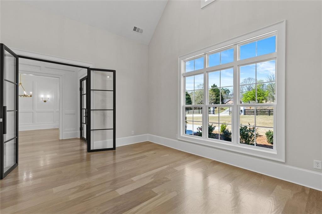 2355 Luke Edwards Road Dacula, GA 30019 - Photo 12 of 115 wooden floor in an empty room with a window