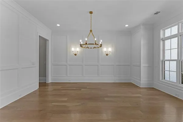 a large kitchen with stainless steel appliances a large counter top a stove a chimney a sink and cabinets