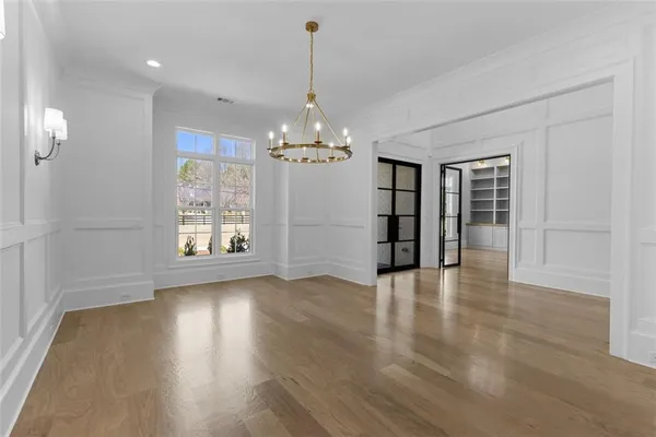 a large kitchen with kitchen island a stove a sink a center island and wooden floor