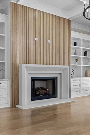 a living room with a flat screen tv and a fireplace