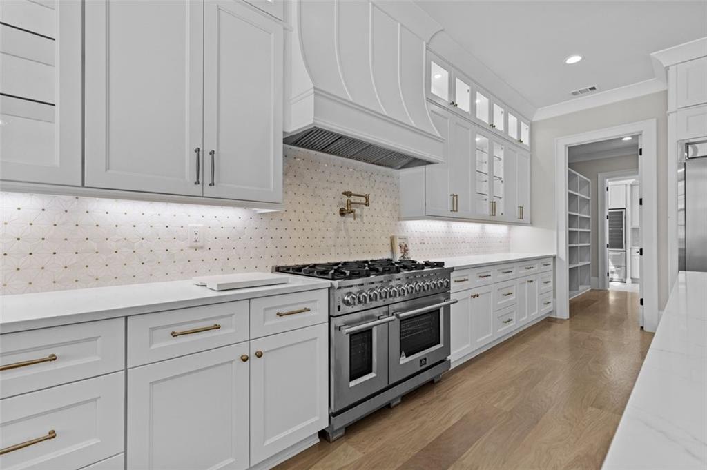 2355 Luke Edwards Road Dacula, GA 30019 - Photo 30 of 115 a kitchen with granite countertop white cabinets and stainless steel appliances