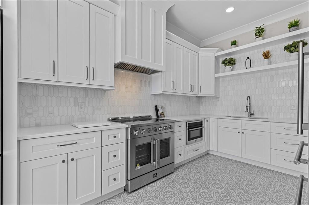 2355 Luke Edwards Road Dacula, GA 30019 - Photo 33 of 115 a kitchen with cabinets stainless steel appliances and sink