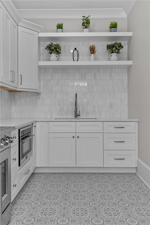 2355 Luke Edwards Road Dacula, GA 30019 - Photo 34 of 115 a kitchen with white cabinets and a stove