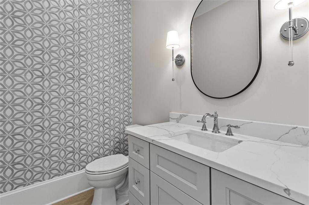 2355 Luke Edwards Road Dacula, GA 30019 - Photo 40 of 115 a bathroom with a sink a toilet and a mirror