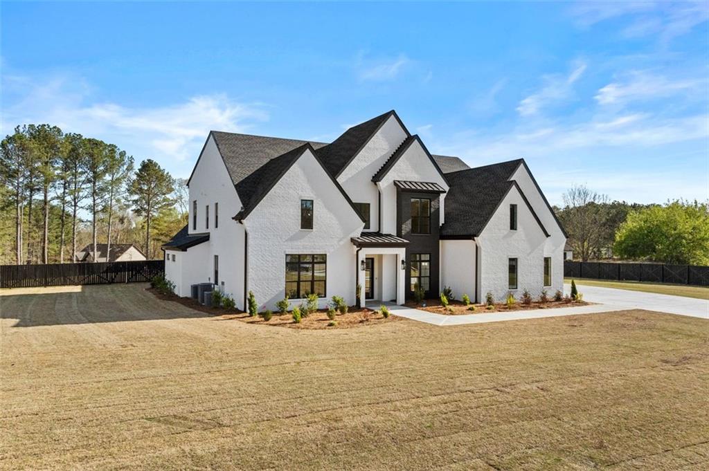 2355 Luke Edwards Road Dacula, GA 30019 - Photo 4 of 115 a front view of a house with a yard