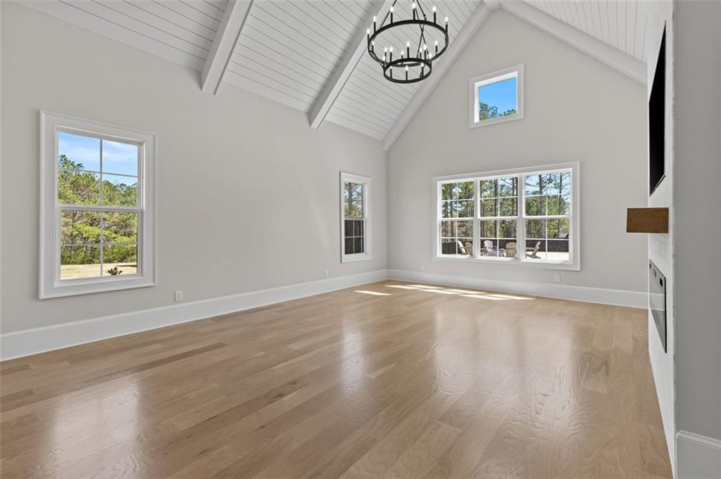 2355 Luke Edwards Road Dacula, GA 30019 - Photo 44 of 115 a view of an empty room with a window and wooden floor