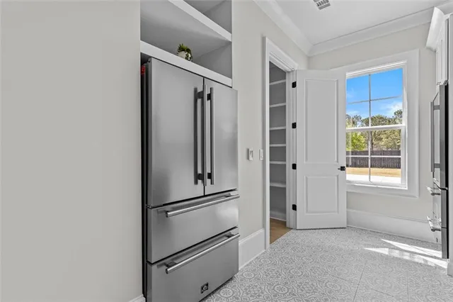 a view of an empty room with a floor to ceiling window and a flat screen tv