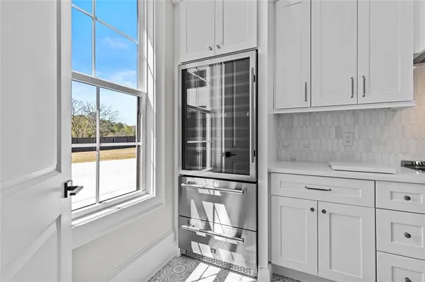 a kitchen with stainless steel appliances a stove and more cabinets