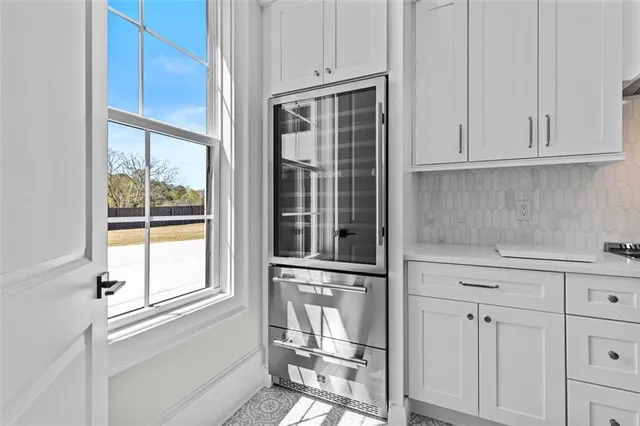 a kitchen with stainless steel appliances a stove and more cabinets