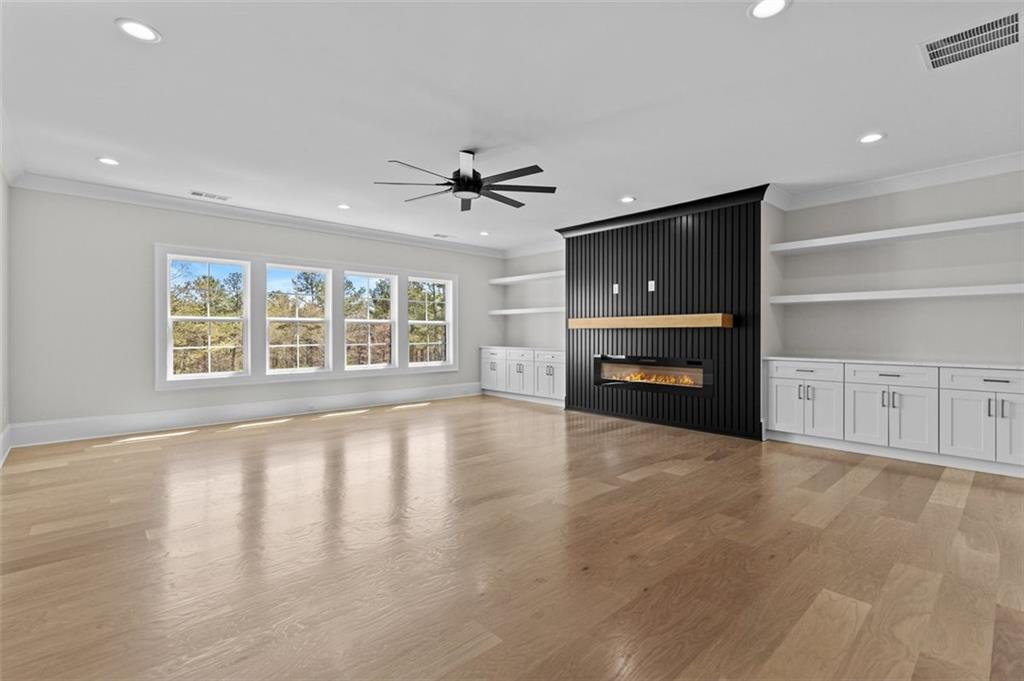 2355 Luke Edwards Road Dacula, GA 30019 - Photo 61 of 115 a view of an empty room with a fireplace and a window