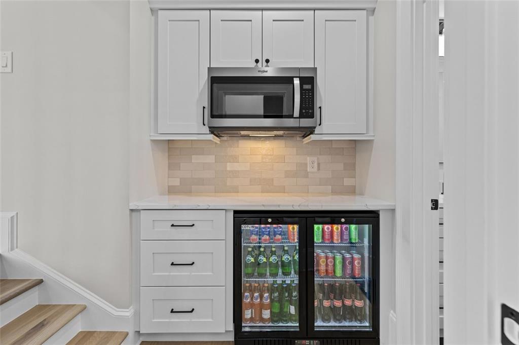 2355 Luke Edwards Road Dacula, GA 30019 - Photo 65 of 115 a kitchen with stainless steel appliances granite countertop a stove microwave and cabinets