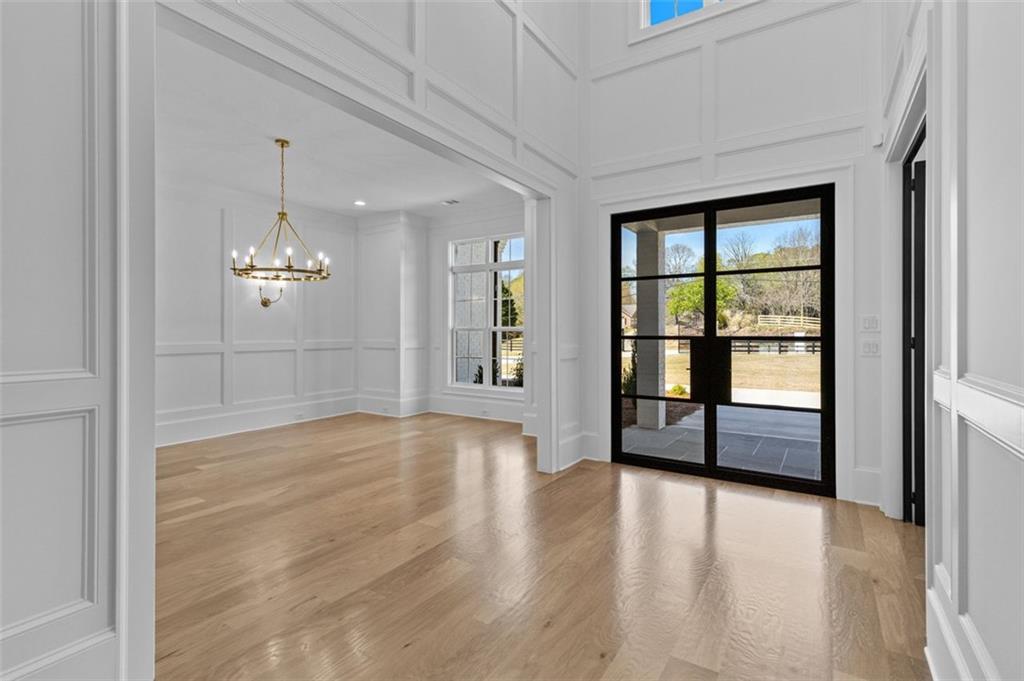 2355 Luke Edwards Road Dacula, GA 30019 - Photo 7 of 115 wooden floor in an empty room with a window