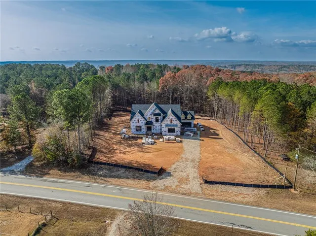 an aerial view of a house with a yard