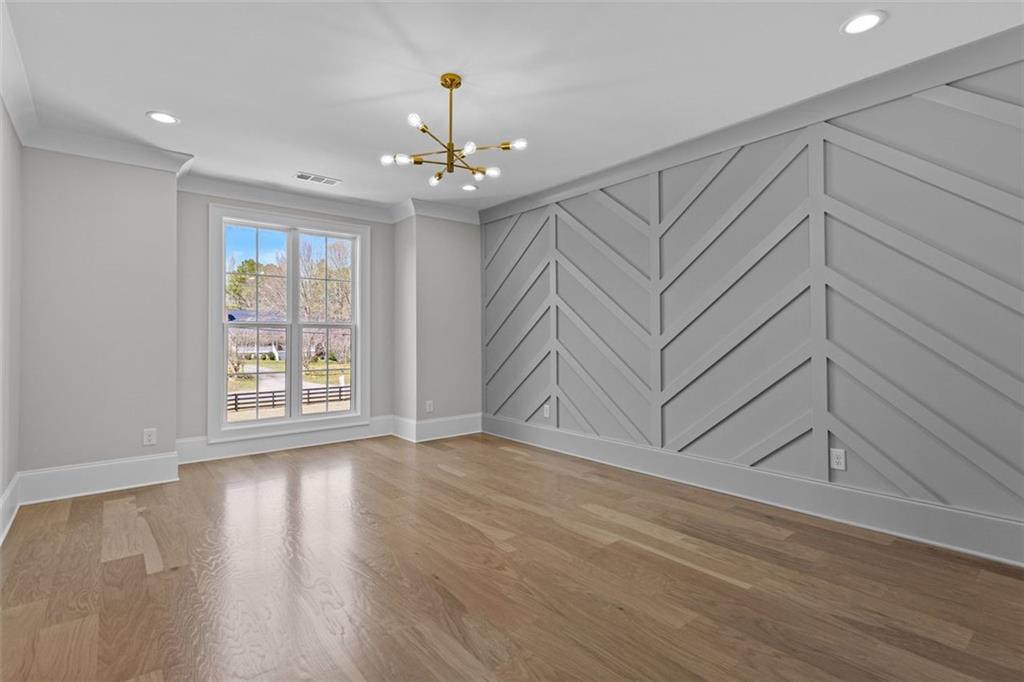 2355 Luke Edwards Road Dacula, GA 30019 - Photo 75 of 115 a view of an empty room with wooden floor and a window