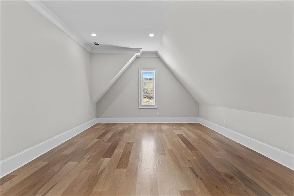 2355 Luke Edwards Road Dacula, GA 30019 - Photo 80 of 115 a view of an empty room with wooden floor and a window