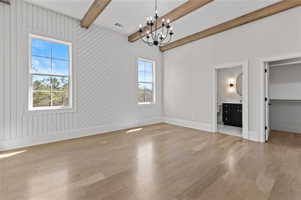 2355 Luke Edwards Road Dacula, GA 30019 - Photo 88 of 115 an empty room with windows and chandelier fan