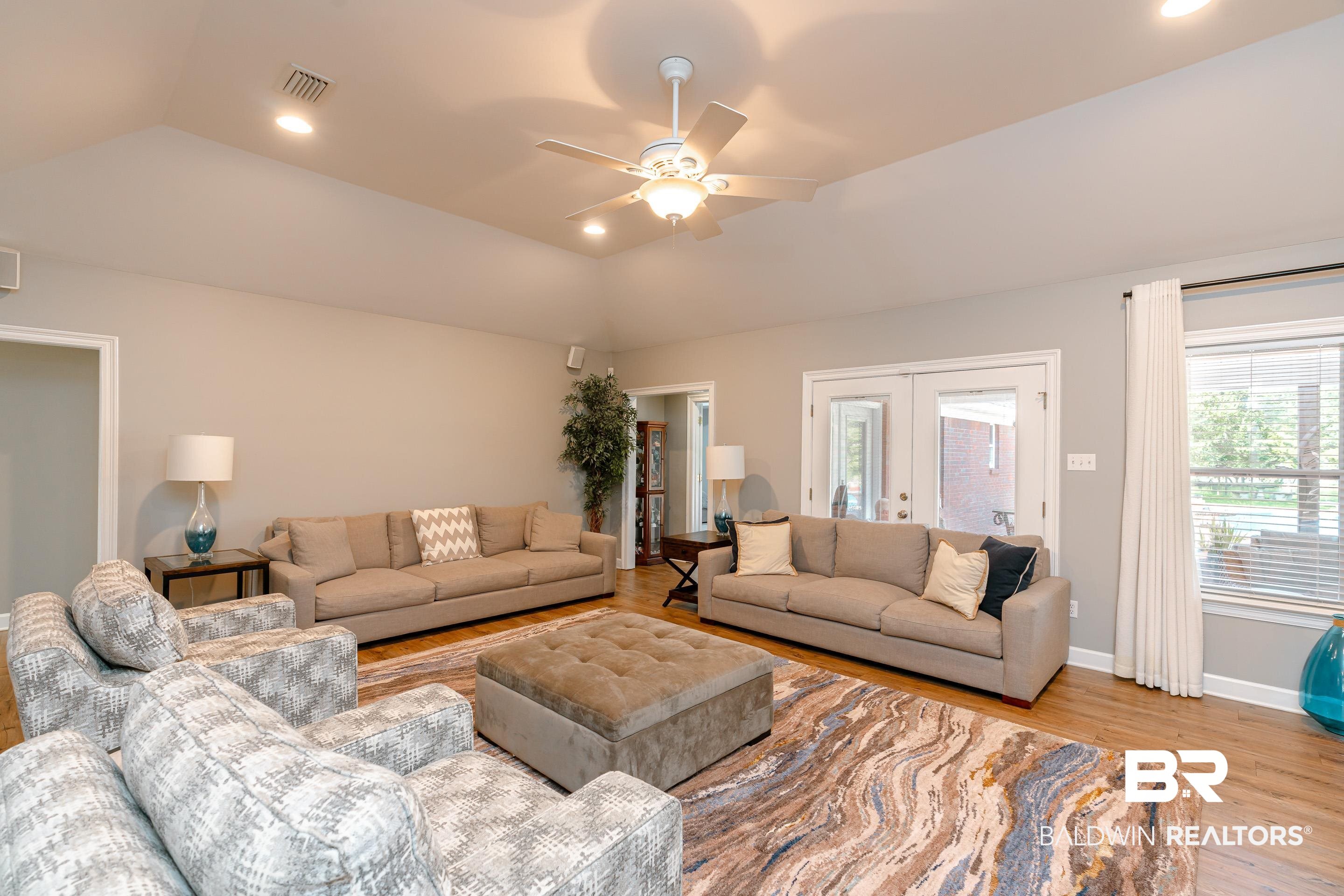 9477 Deerfield Drive Irvington, AL 36544 - Photo 7 of 58 Living room with light hardwood / wood-style flooring, ceiling fan, french doors, and lofted ceiling