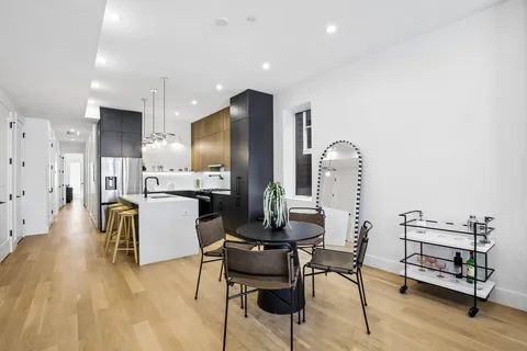 a living room with furniture and kitchen view