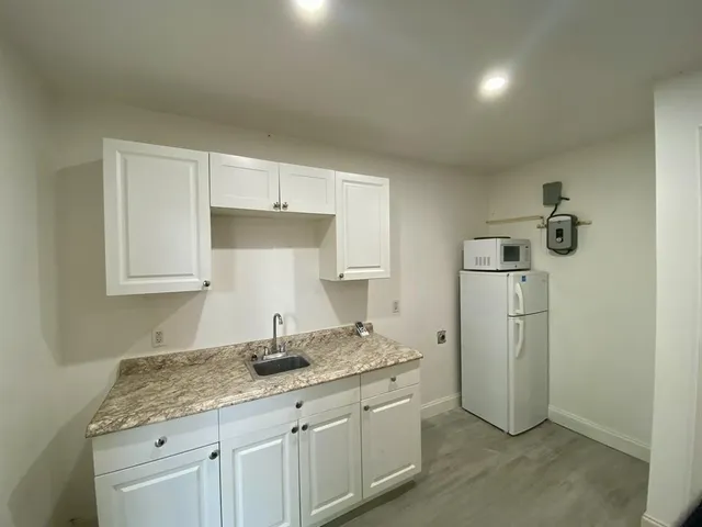 a kitchen with a sink and refrigerator