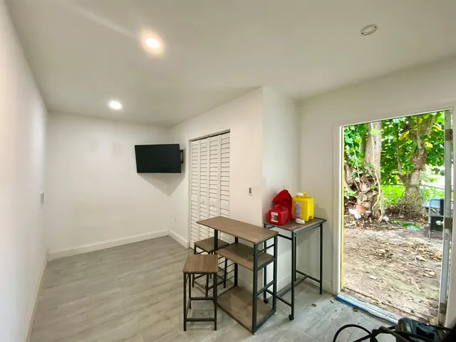 a view of a room with furniture and wooden floor
