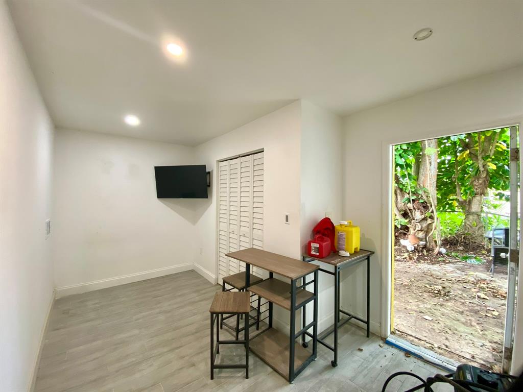 14131 Northwest 3rd Avenue, Unit D Miami, FL 33168 - Photo 6 of 8 a view of a room with furniture and wooden floor