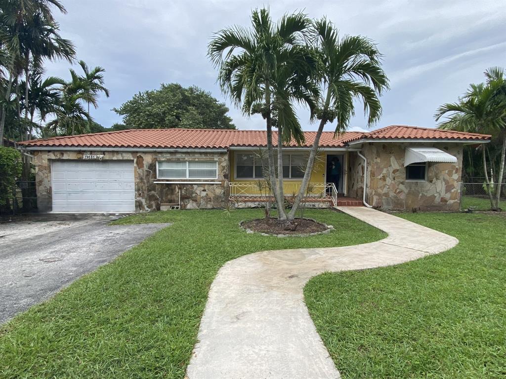 14131 Northwest 3rd Avenue, Unit D Miami, FL 33168 - Photo 8 of 8 a front view of a house with garden