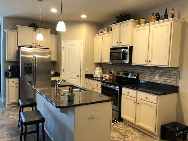 350 Pin Oak Loop Santa Rosa Beach, FL 32459 - Photo 8 of 26 a kitchen with stainless steel appliances granite countertop a sink a stove and a refrigerator