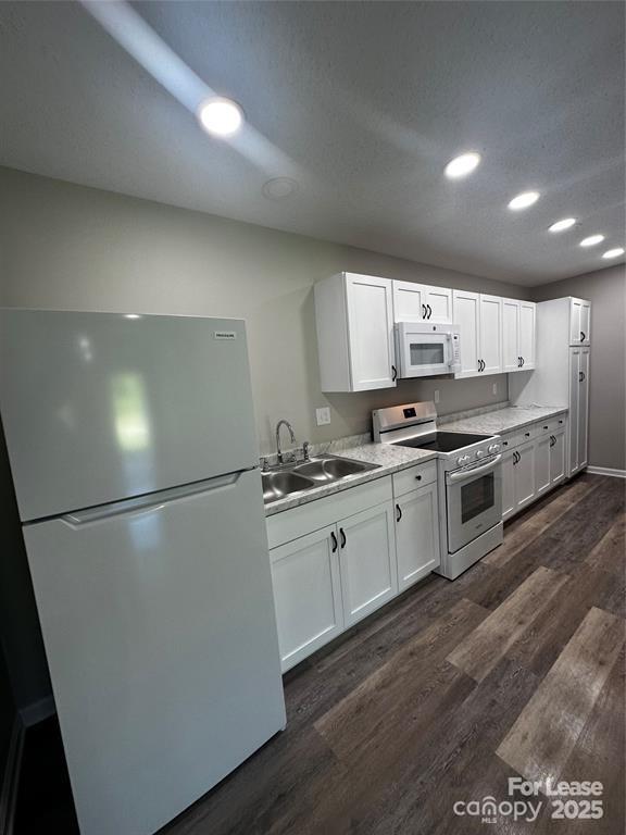 43 Hawkins Road, Unit 2 Marion, NC 28752 - Photo 3 of 10 a kitchen with stainless steel appliances granite countertop a refrigerator a stove a sink dishwasher and white countertops with wooden floor