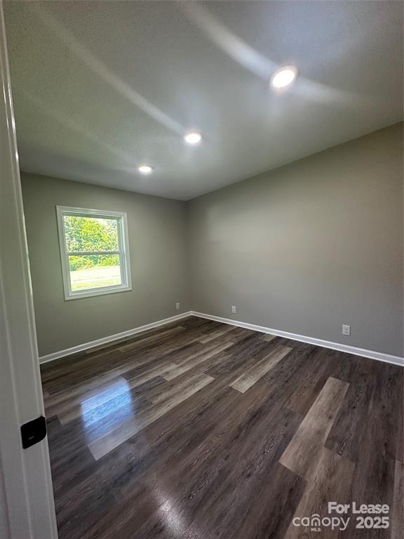 43 Hawkins Road, Unit 2 Marion, NC 28752 - Photo 4 of 10 an empty room with wooden floor and windows