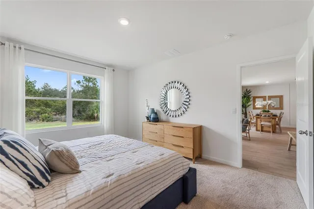 a bedroom with a large bed and a dresser