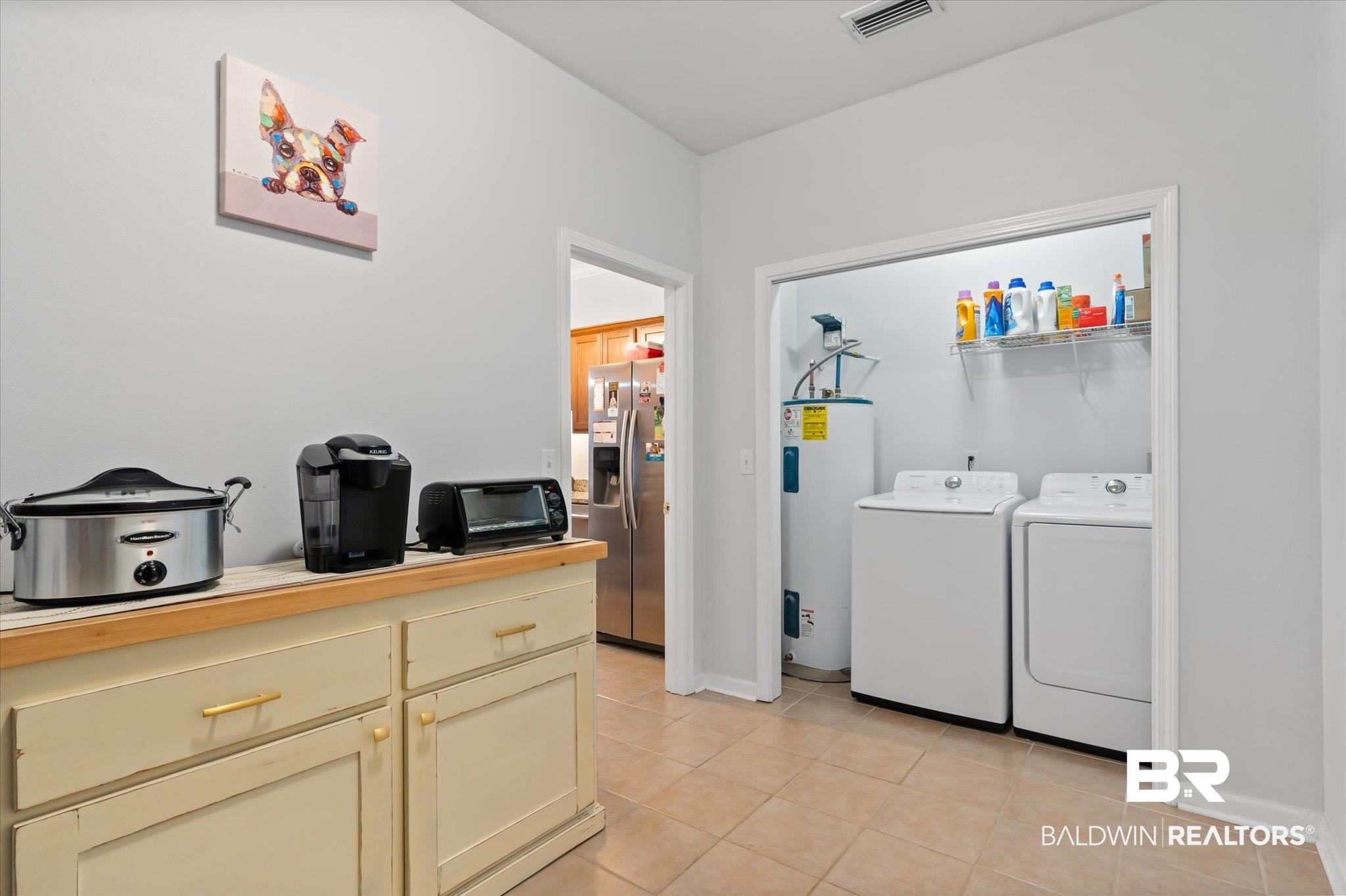 3876 Emerille Drive Foley, AL 36535 - Photo 23 of 31 Laundry room featuring washing machine and clothes dryer, light tile patterned floors, and electric water heater