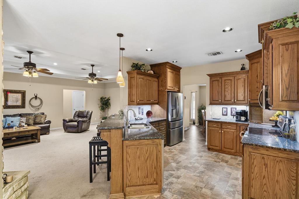 9111 County Road 313 Terrell, TX 75161 - Photo 20 of 40 a kitchen with refrigerator and cabinets
