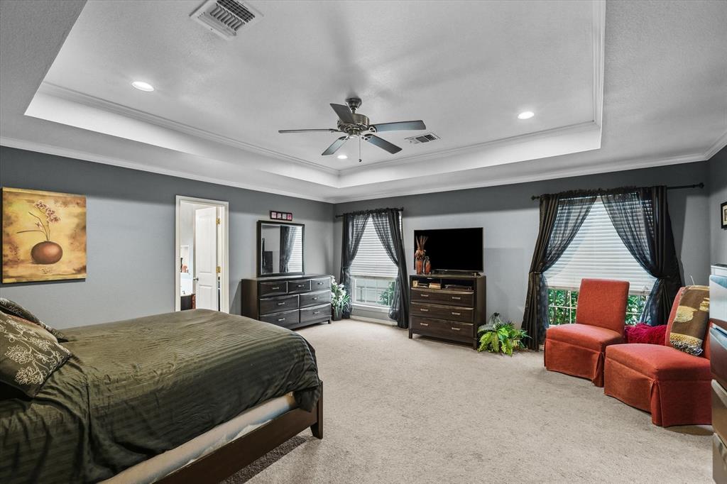 9111 County Road 313 Terrell, TX 75161 - Photo 23 of 40 a bedroom with a bed a couch and a flat screen tv