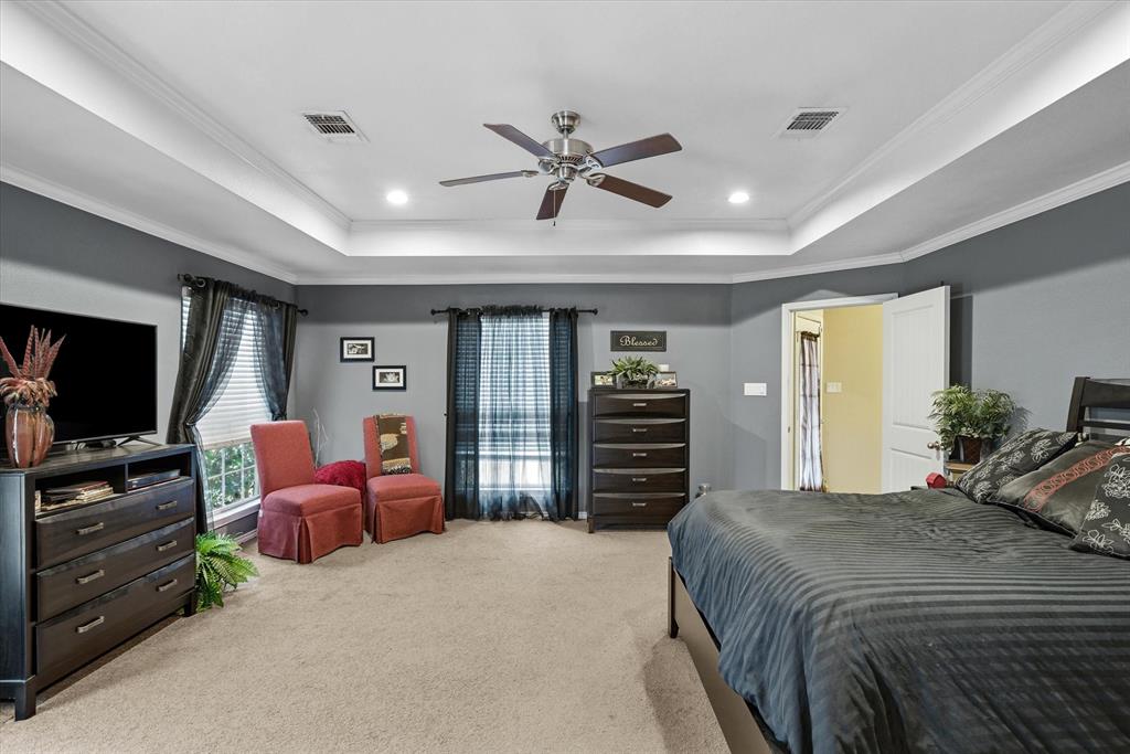 9111 County Road 313 Terrell, TX 75161 - Photo 24 of 40 a bedroom with a bed and a flat screen tv