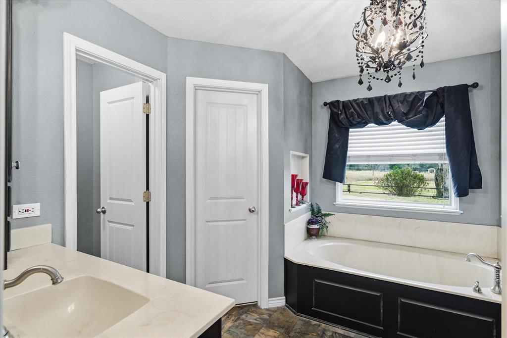 9111 County Road 313 Terrell, TX 75161 - Photo 25 of 40 a bathroom with a sink a shower and a mirror