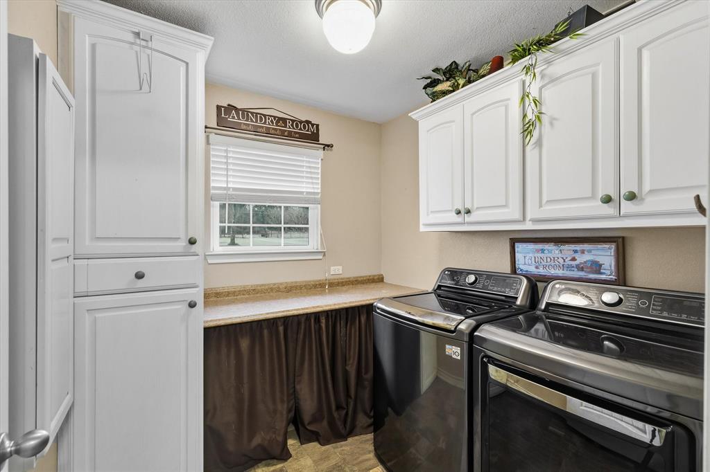9111 County Road 313 Terrell, TX 75161 - Photo 34 of 40 a kitchen with stainless steel appliances granite countertop a stove a sink and a microwave