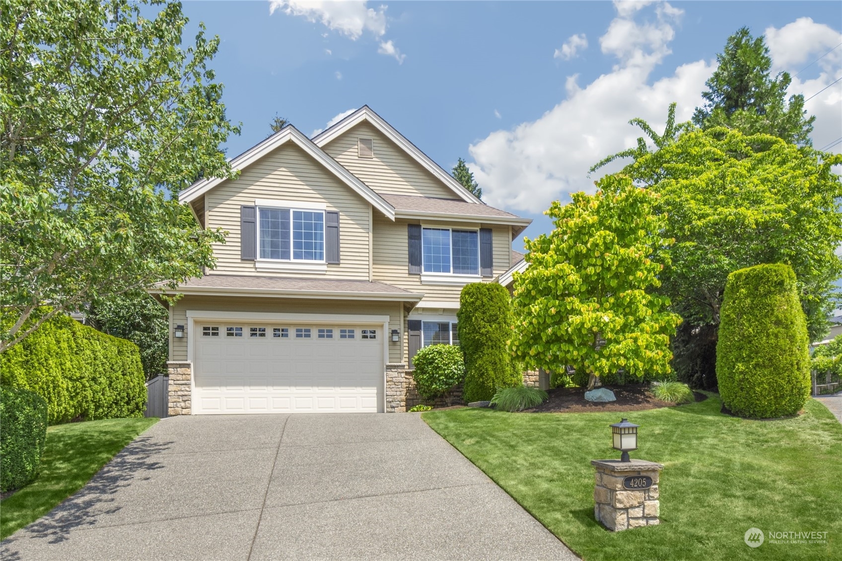 4205 221st Place Southeast Bothell, WA 98021 - Photo 1 of 32 a front view of a house with a yard and garage