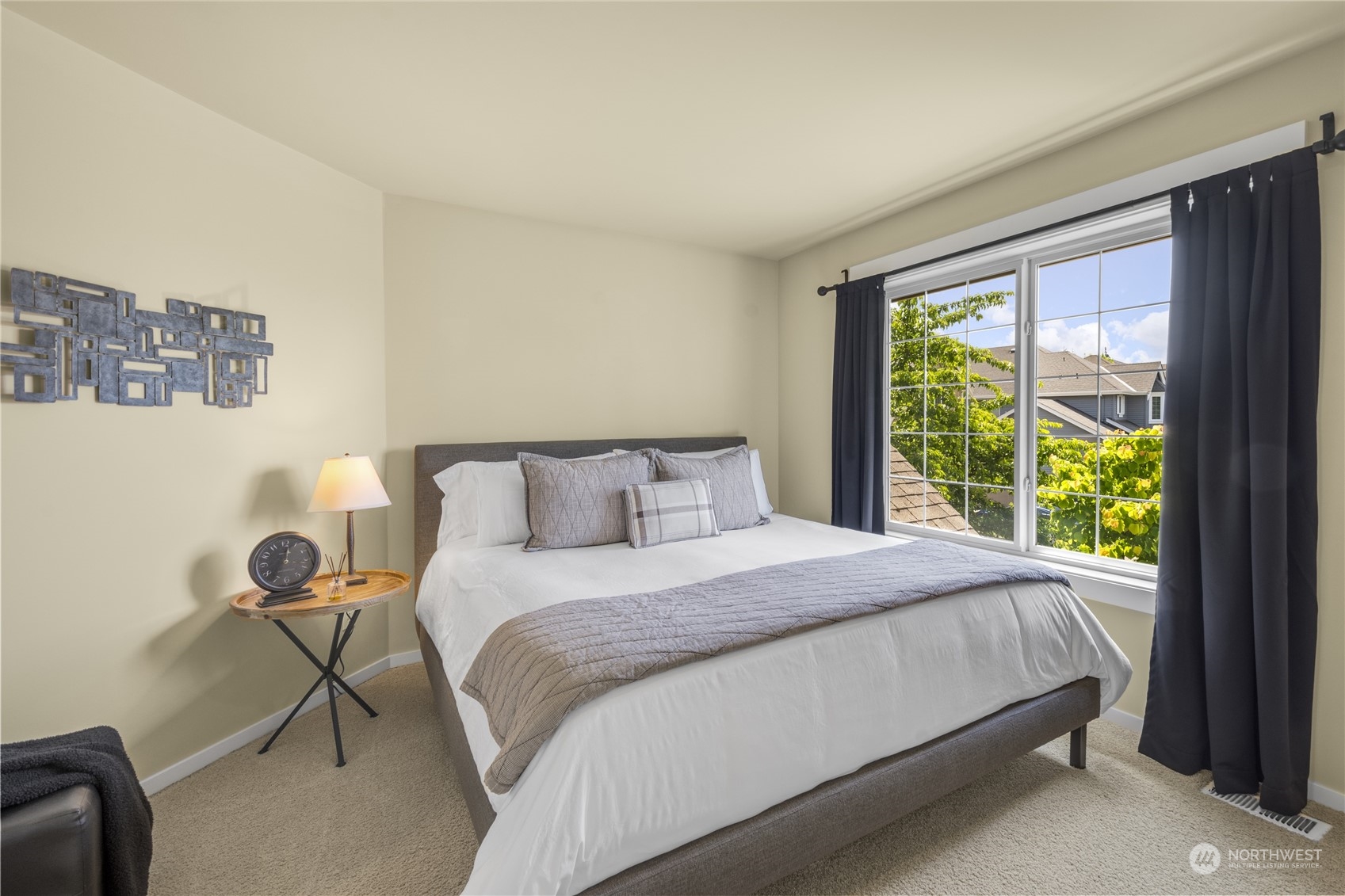 4205 221st Place Southeast Bothell, WA 98021 - Photo 24 of 32 a large bed sitting in a bedroom next to a window