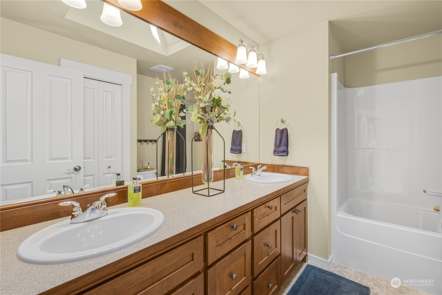 4205 221st Place Southeast Bothell, WA 98021 - Photo 25 of 32 a bathroom with a granite countertop sink and a mirror