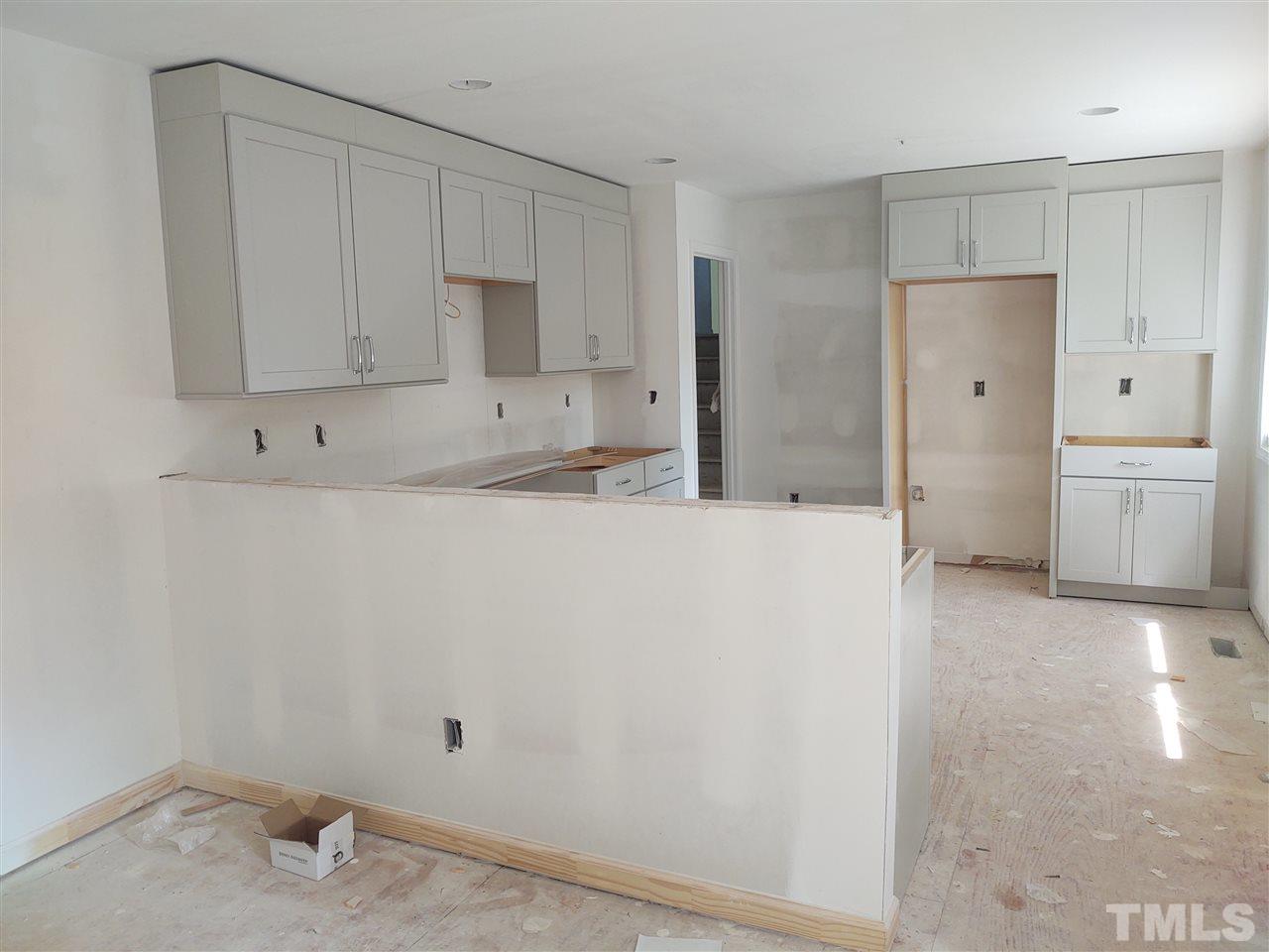 3108 Orton Place Raleigh, NC 27607 - Photo 3 of 8 a kitchen with refrigerator and cabinets