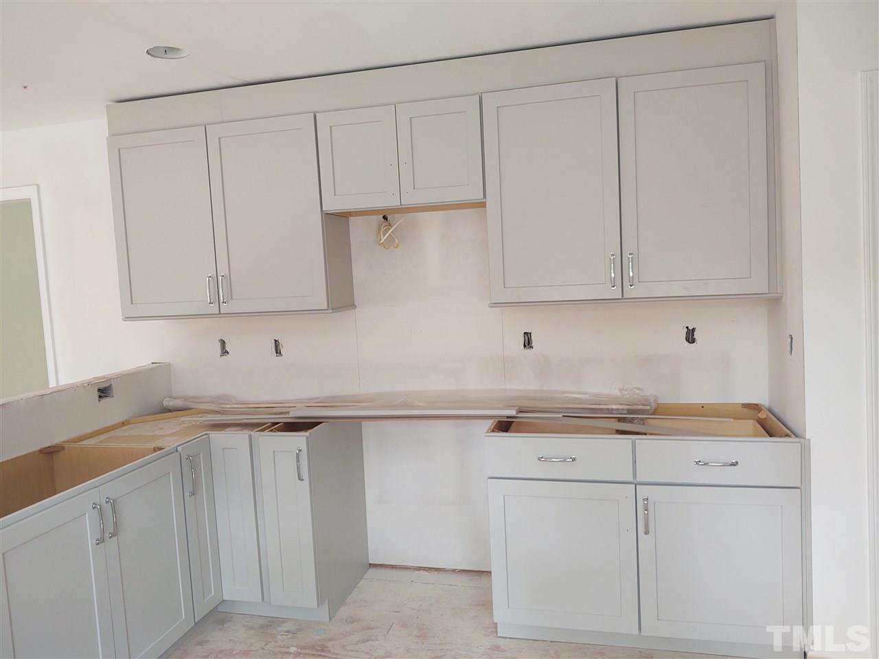 3108 Orton Place Raleigh, NC 27607 - Photo 5 of 8 a kitchen with white cabinets