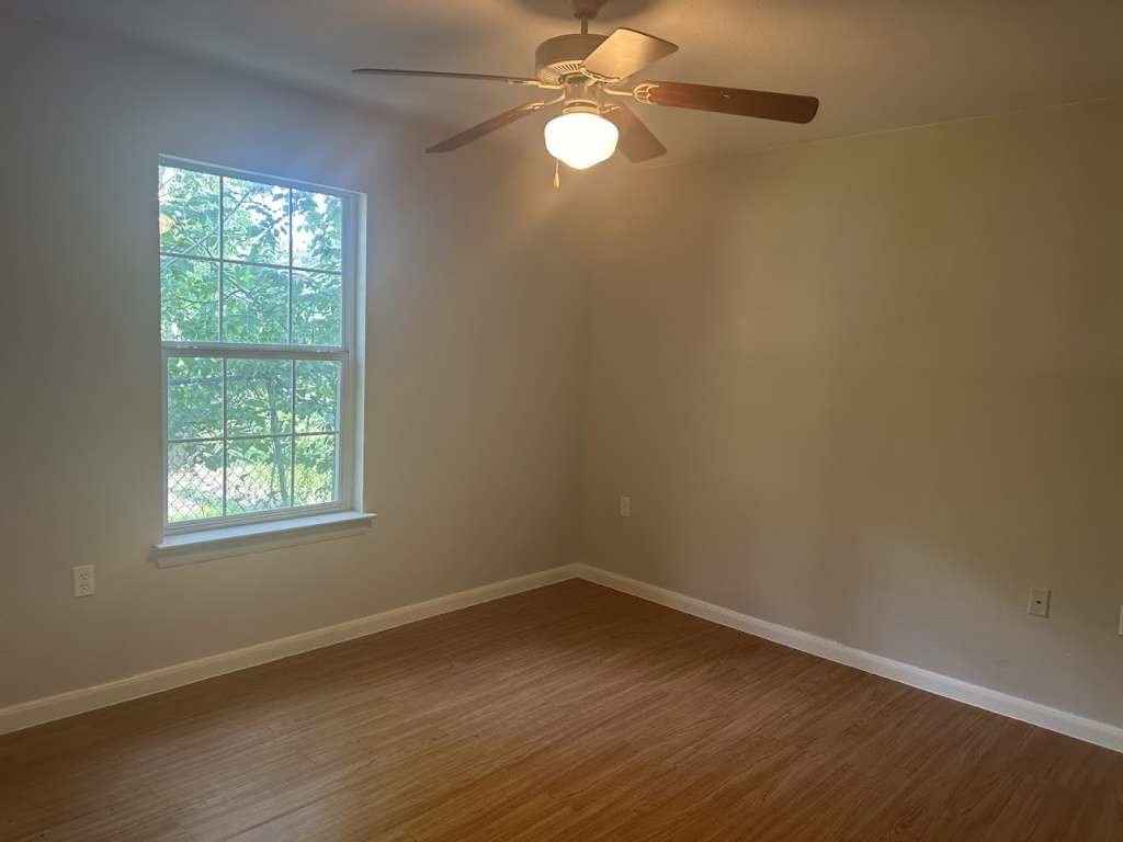 3418 Memel Street Houston, TX 77026 - Photo 11 of 19 an empty room with wooden floor and windows