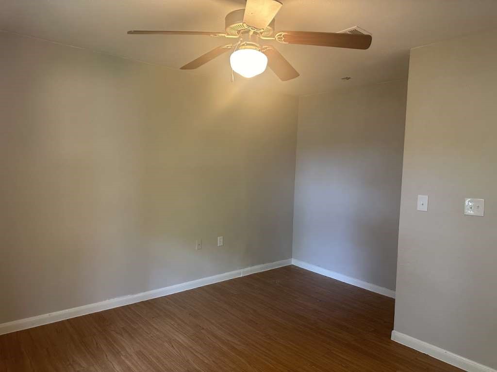 3418 Memel Street Houston, TX 77026 - Photo 13 of 19 a view of an empty room with wooden floor and a window
