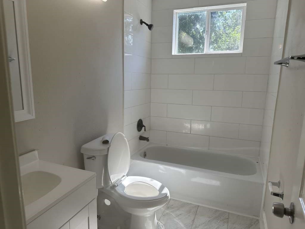 3418 Memel Street Houston, TX 77026 - Photo 15 of 19 a bathroom with a sink toilet and shower