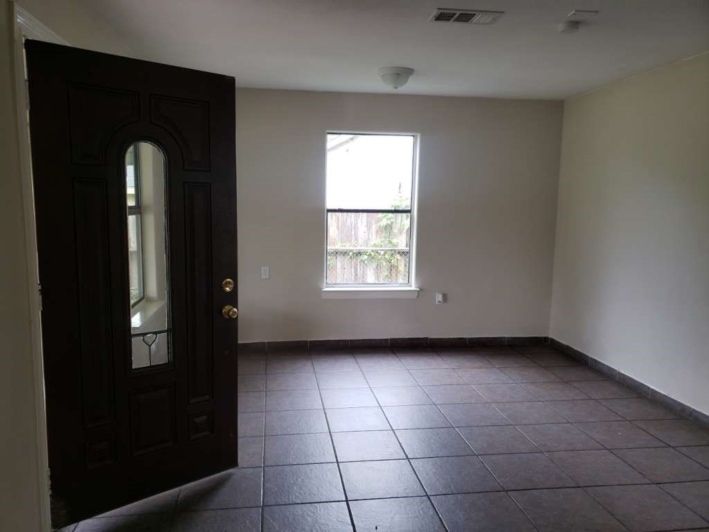 3418 Memel Street Houston, TX 77026 - Photo 4 of 19 a view of an empty room with a window