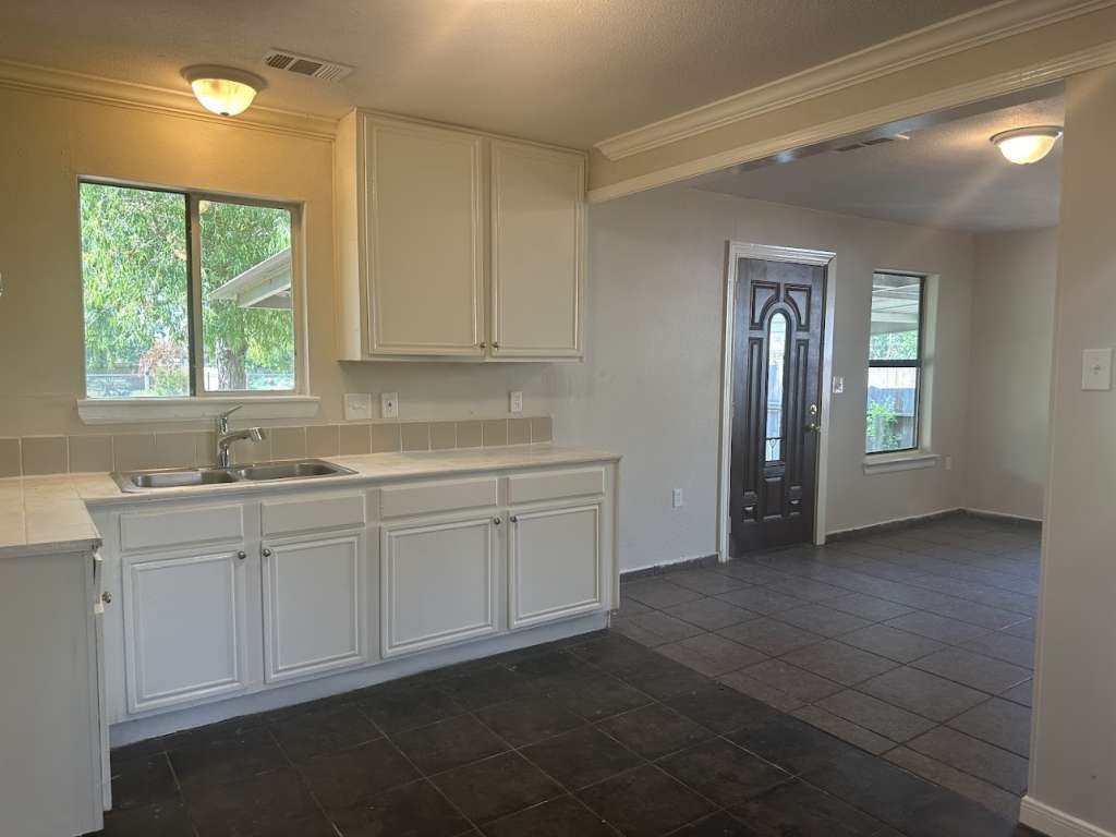 3418 Memel Street Houston, TX 77026 - Photo 9 of 19 a kitchen with sink cabinets and window