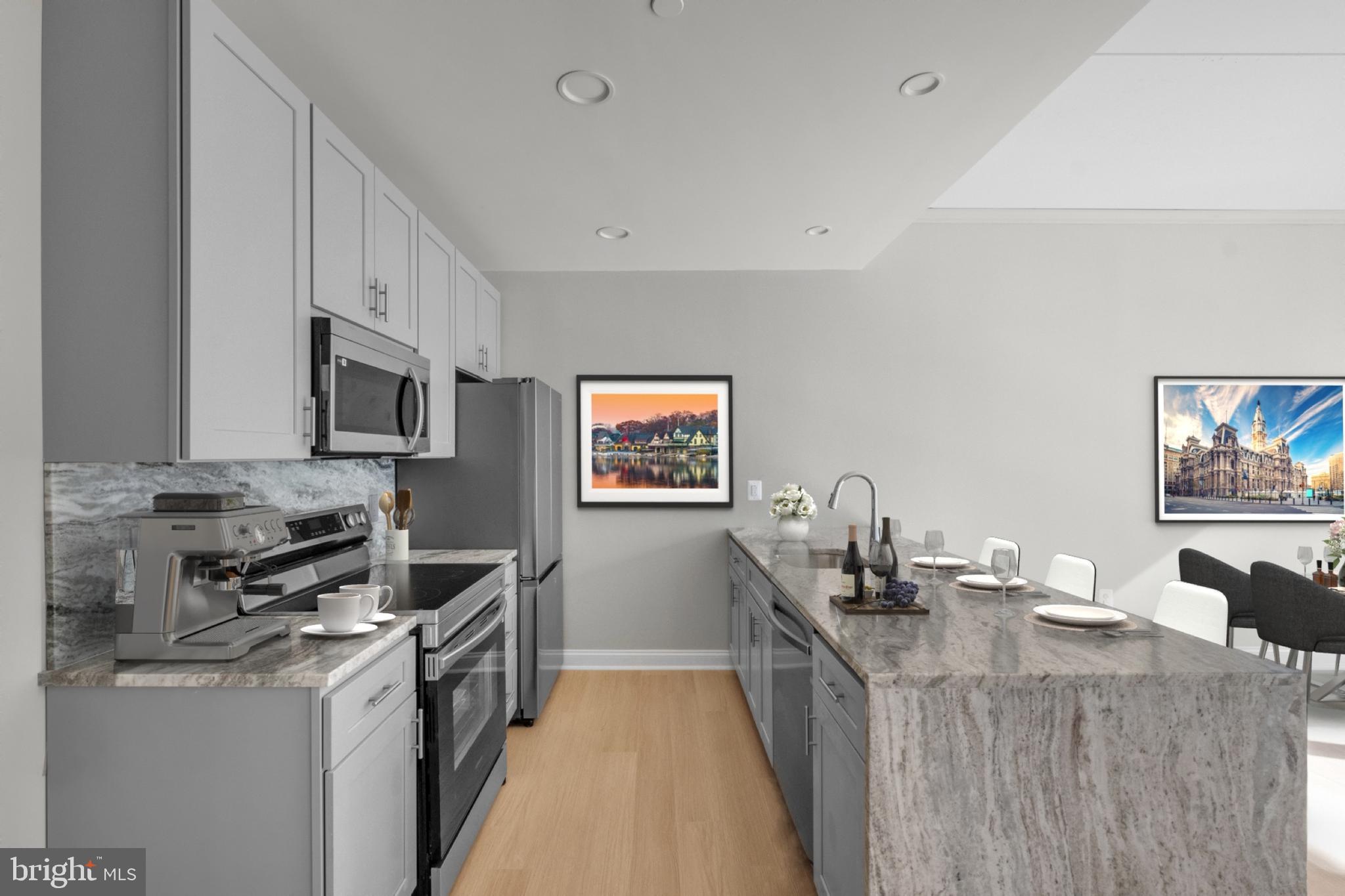 2301-61 John F Kennedy Boulevard, Unit 315 Philadelphia, PA 19103 - Photo 6 of 39 a kitchen with stainless steel appliances a stove refrigerator sink and microwave