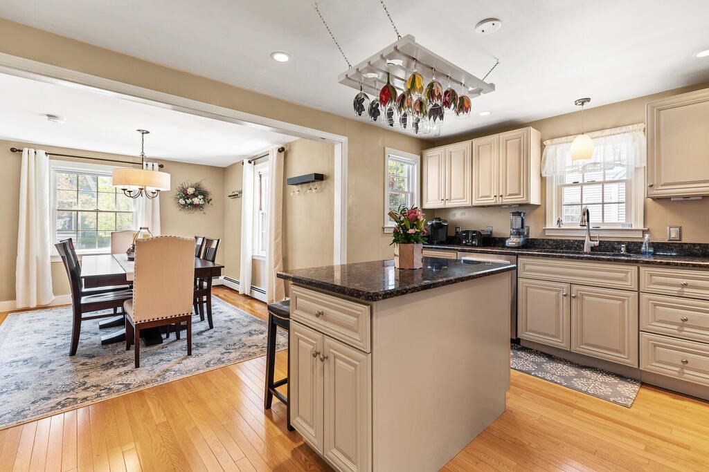 81 Baxter Street Melrose, MA 02176 - Photo 12 of 33 a kitchen with stainless steel appliances granite countertop a stove top oven a sink dishwasher and white cabinets with wooden floor