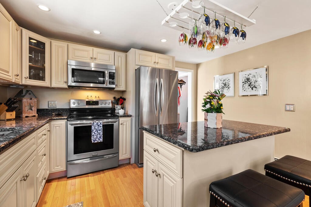 81 Baxter Street Melrose, MA 02176 - Photo 13 of 33 a kitchen with stainless steel appliances granite countertop a refrigerator a stove top oven a sink and dishwasher
